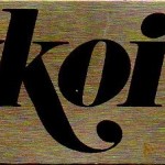 A metal tag from an Auditron Radio programmed specifically to 93.7 FM WKOI Pittsburgh.