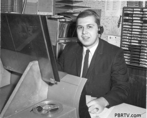 Bob Kristof at the FM board (just across the glass from the AM board). Note my audio sources, reel to reel tape, two turntables to my right, 45 and 33 rpm records, cartridges behind me, and to my left the equipment rack with two RCA cart players. It sounded like loading a torpedo when you put those carts in.